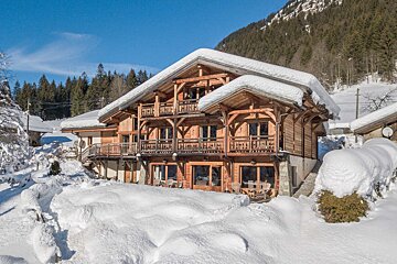 A snowy deck with a mountain in the background