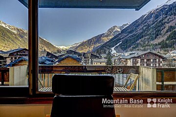 A chair in front of a window that says mountain base on it
