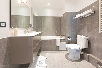 A bathroom with a toilet a sink and a bathtub