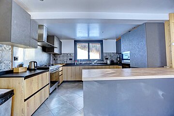 A kitchen with wooden cabinets and stainless steel appliances