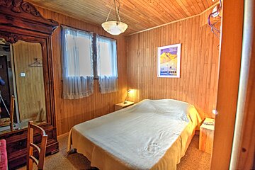 A bedroom with a poster on the wall that says home park