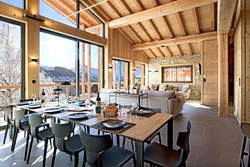 A dining room table with plates and glasses on it