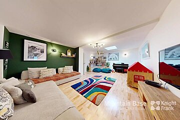 A living room with a couch a rug and a television sponsored by knight frank