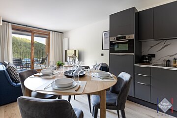 A kitchen with a rental designer logo on the corner