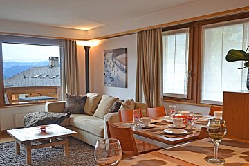 A living room with a couch and a painting on the wall