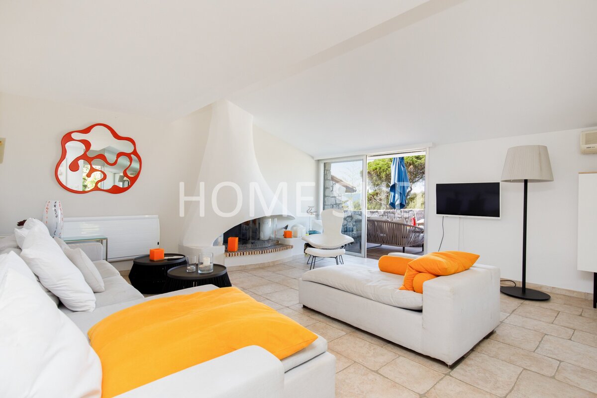 A living room with a fireplace and the word home on the wall