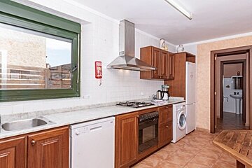 A kitchen with a fire extinguisher on the wall