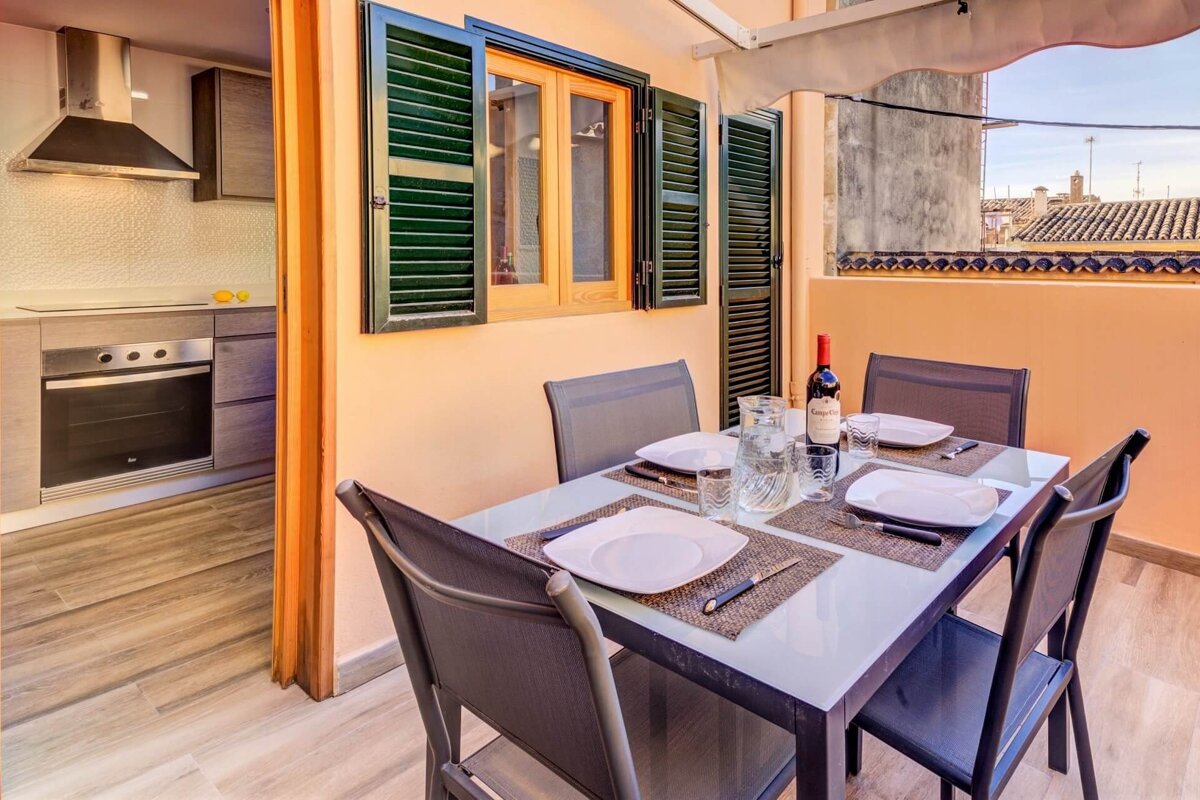 A bottle of wine sits on a table in front of a window