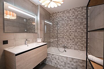 A bathroom with a bathtub and a sink