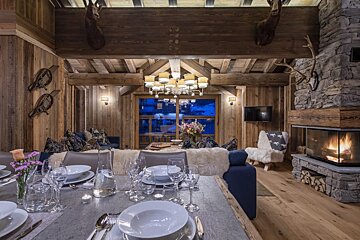 A dining room table with plates and glasses on it