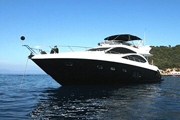 A black and white boat is floating in the water