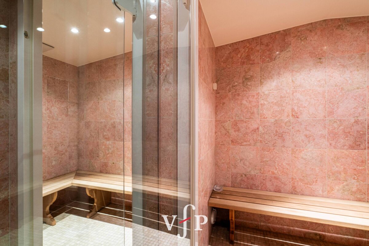 A bathroom with pink tiles and a sign that says vip