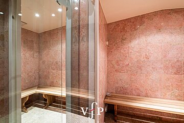 A bathroom with pink tiles and a sign that says vip