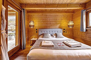 A bedroom with a bed and a sign that says mountain easy immobilier real estate