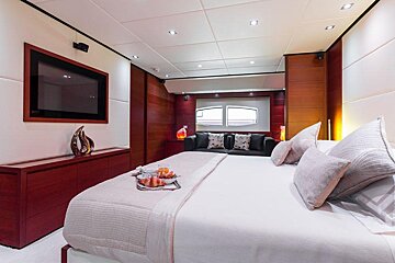 A bedroom with a large bed and a flat screen tv