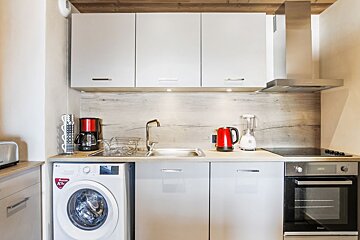 A kitchen with a lg brand washer and dryer