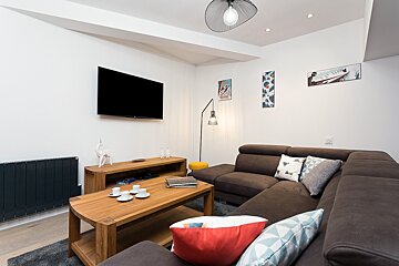 A living room with a couch and a flat screen tv