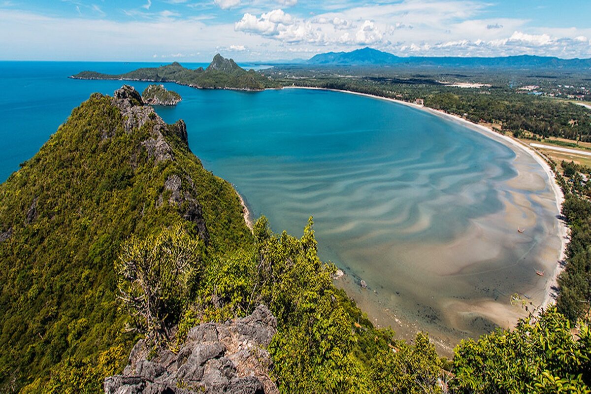 A large body of water surrounded by mountains and trees