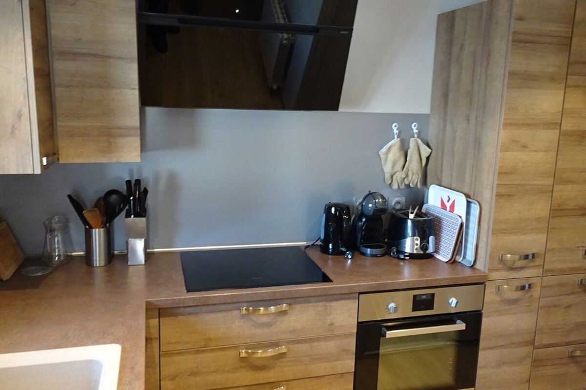 A kitchen with wooden cabinets and a stove top oven