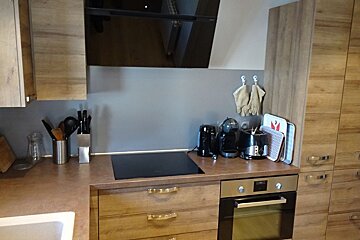 A kitchen with wooden cabinets and a stove top oven