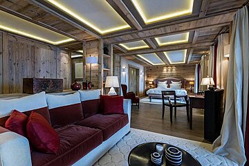A living room with a couch and a desk