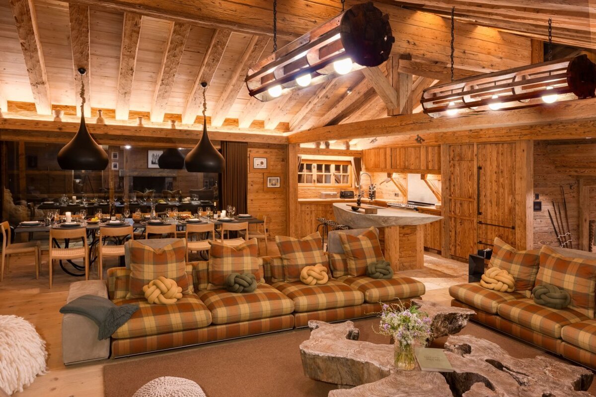 A living room with plaid couches and a wooden table
