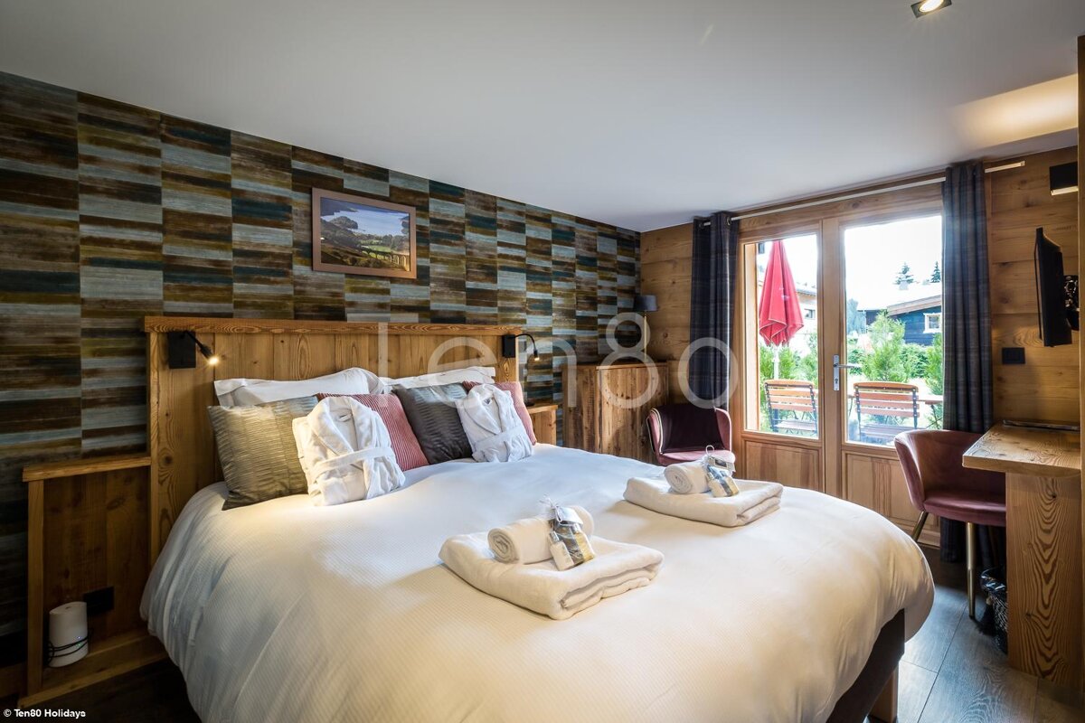 A hotel room with a large bed and a tv