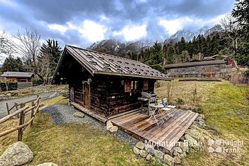 A small wooden cabin with a metal roof is for sale by mountain base knight frank
