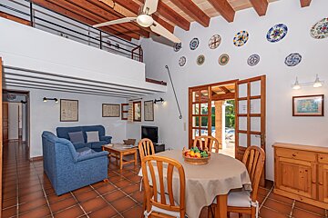 A living room with a blue couch and a table