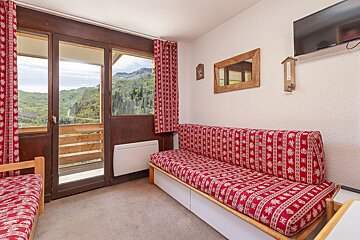 A living room with a couch and a flat screen tv