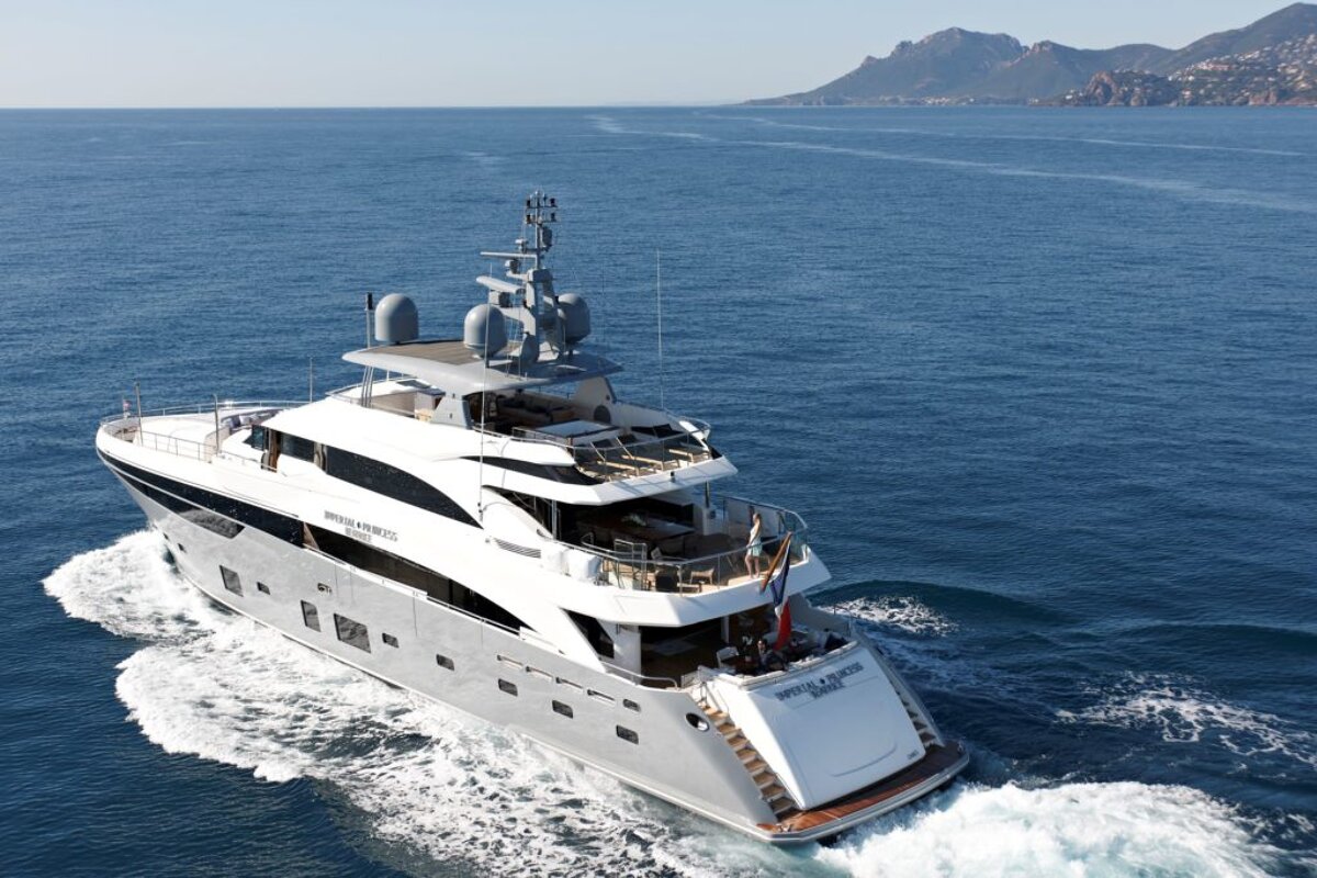 A large yacht is floating on top of a body of water