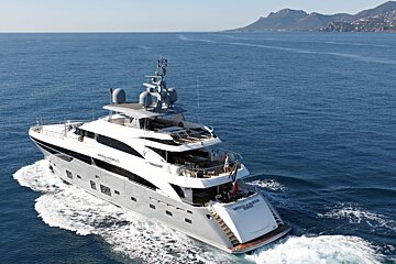 A large yacht is floating on top of a body of water