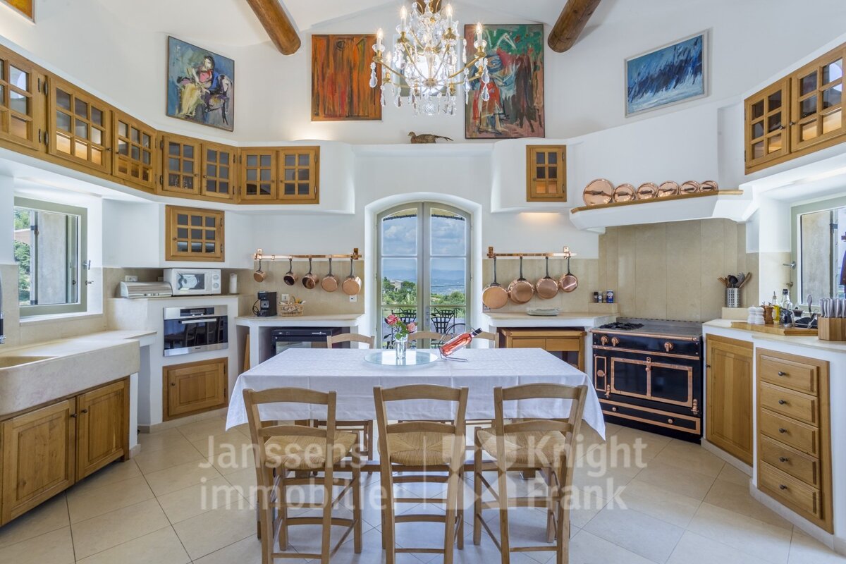A kitchen with a table and chairs and the words janssen knight frank on the bottom