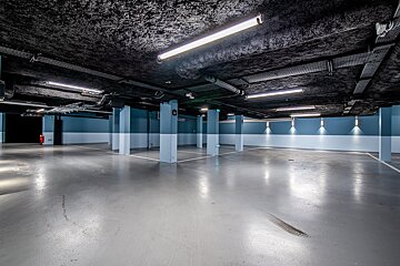 An empty parking garage with blue and white walls