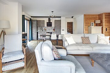 A living room with a couch a chair and a lamp