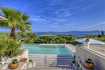 A large swimming pool with a view of the ocean