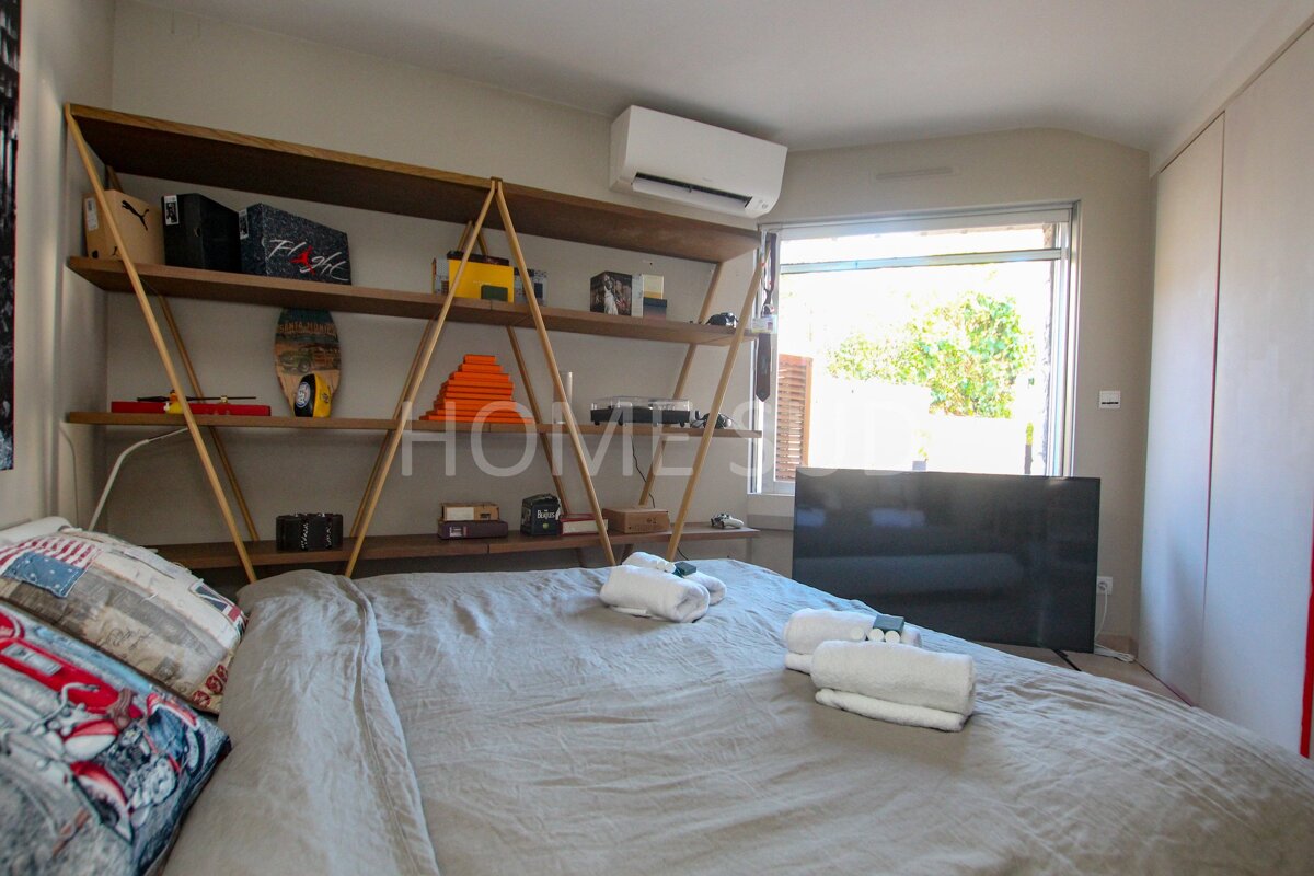 A bedroom with a shelf that says home on it