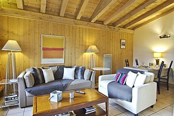 A living room with a couch a chair and a table