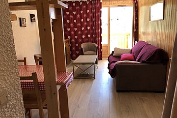 A living room with a couch a chair and a table