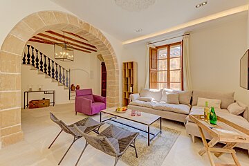A living room with a couch and two chairs