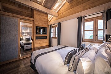 A bedroom with a bed and a sign that says chalet tango