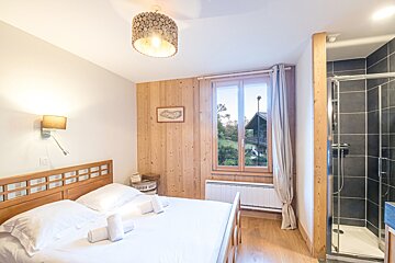 A bedroom with a bed and a picture on the wall