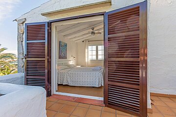 A bedroom with two beds and a painting on the wall