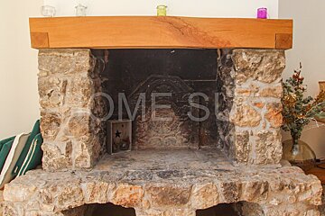 A stone fireplace with the word home written on it