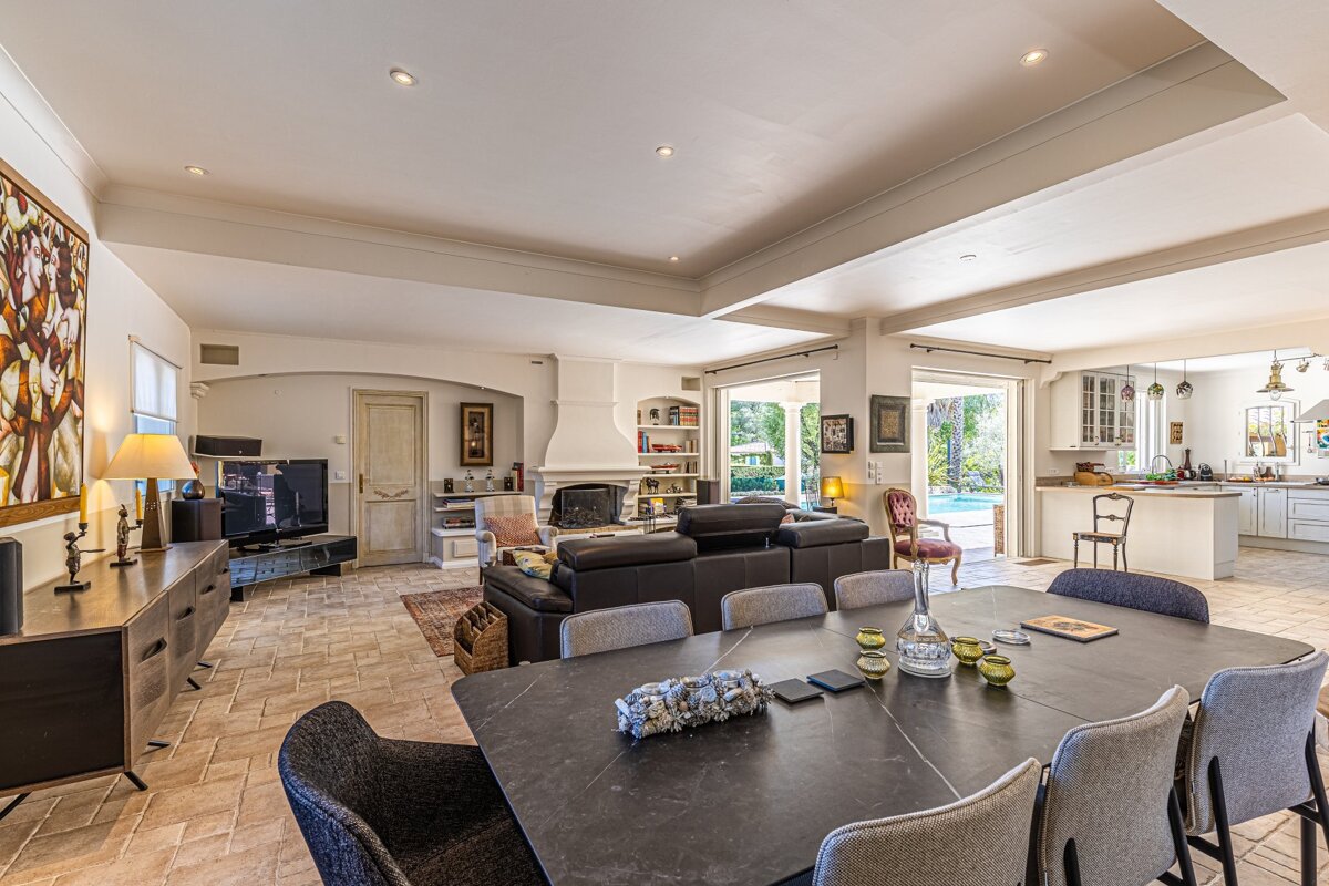 A living room with a dining table and chairs