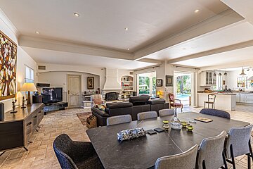 A living room with a dining table and chairs