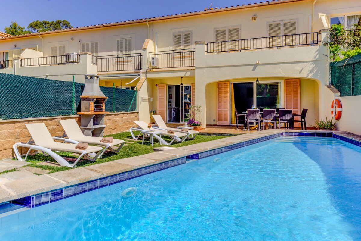 A house with a swimming pool in front of it