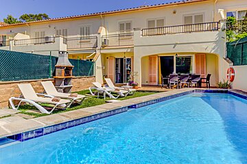 A house with a swimming pool in front of it