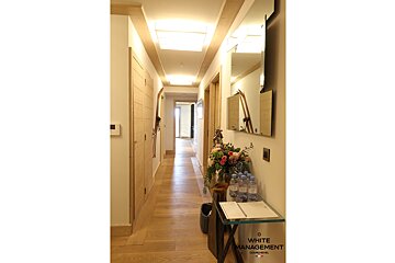 A long hallway with a white management sign on the wall