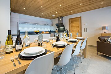 A bottle of passage wine sits on a dining table